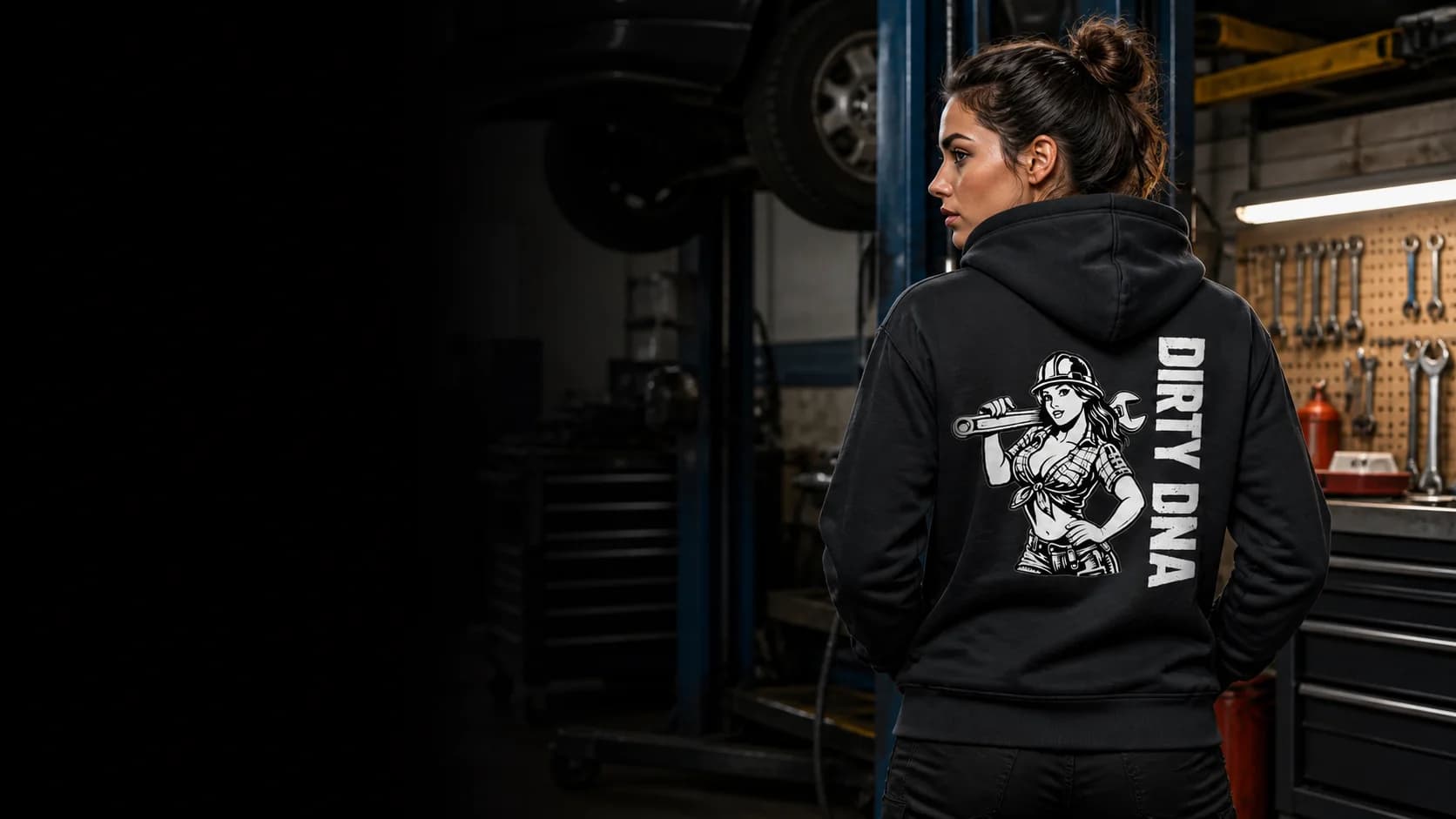 Mechanic wearing the Dirty DNA mechanic hoodie in a service garage